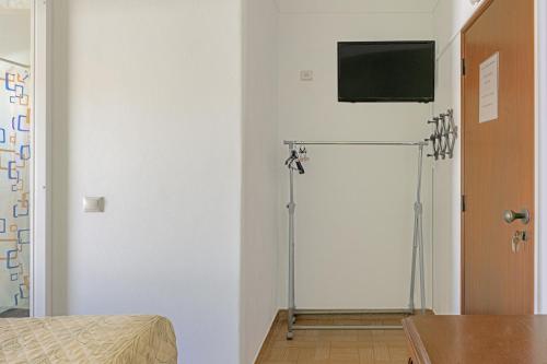 a room with a flat screen tv on a wall at Casa Margarida Malveiro in Odeceixe