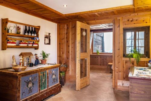 a kitchen with wood paneling and a wooden door at Feldererhof GsiesApt Dolomitenblick in Valle Di Casies
