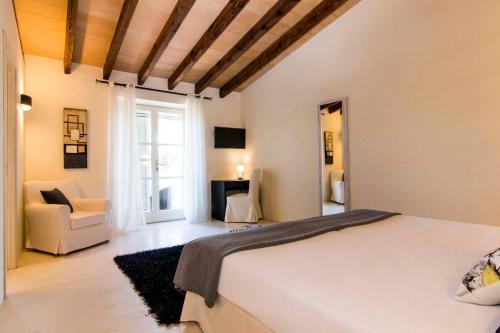 a bedroom with a bed and a living room at Can Bossa in Capdepera