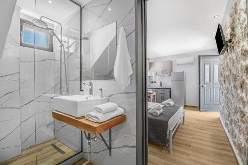 a bathroom with a sink and a shower at Groundfloor Studio 1 in Tsoukalades