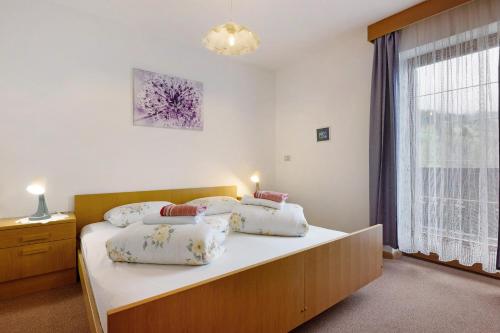 a bedroom with a bed with two pillows on it at Schnellehof in Velturno