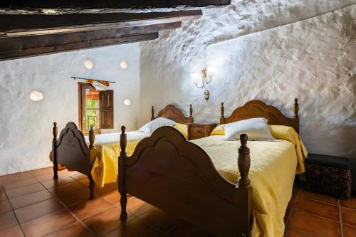 a bedroom with two beds and a window at Moli d' en Pi in Morella