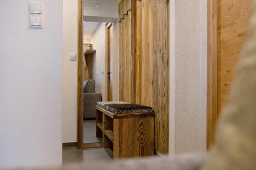 a hallway with a stool in front of a mirror at Gurschlerhof in Lasa