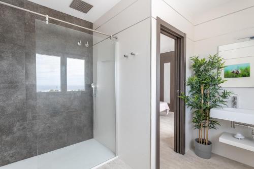 a bathroom with a shower with a glass door at Nerja Luxury Apartment in Nerja
