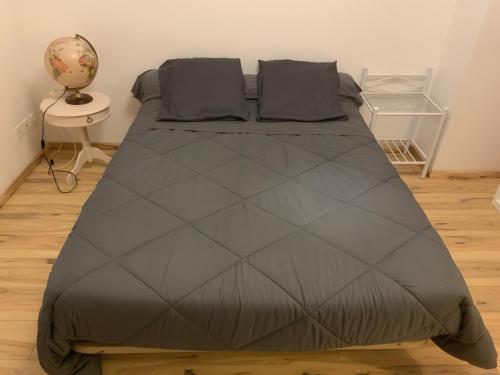 a large bed in a room with a table at Maison de Violette in Serrières-de-Briord