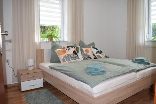 a bedroom with a bed with pillows on it at Ferienwohnung Jacobi in Weißenfels