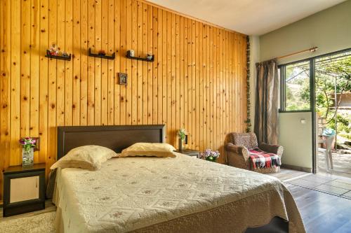 a bedroom with a bed in a room with wooden walls at Vangelis studio 2 in Kefalonia