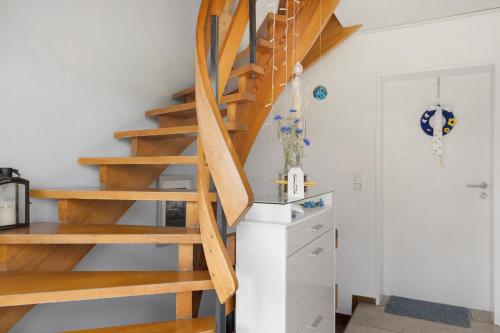 a spiral staircase in a room with a desk at Ferienwohnung Lemke in Donaueschingen