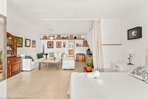 a room with two beds and a living room at Apartamento Cipreses in Puerto del Carmen