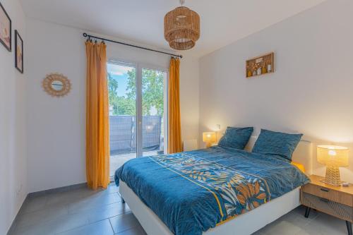 a bedroom with a bed and a large window at La p'tite maison de Charlotte in Cissac-Médoc
