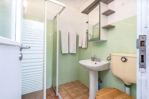 a bathroom with a sink and a shower at Casa da Praia 2 in Budens
