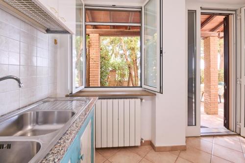 a kitchen with a sink and a window at Blu - Euroappartamenti in San Vincenzo