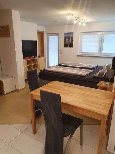 a room with a bed and a table and chairs at Casa Rindler in Sigmarszell