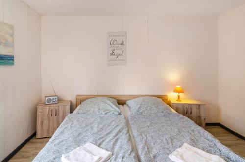 a bedroom with a bed and two night stands at Haus am Rand des Harz in Bad Lauterberg