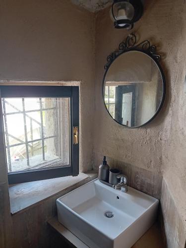 a bathroom with a sink and a mirror and a window at Glamping C Selva Tenda Ciliegio in Piano Porlezza