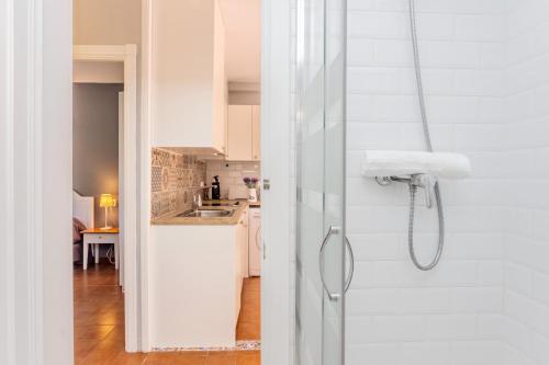 a bathroom with a shower with a glass door at Villa Seve in Cala en Bosc