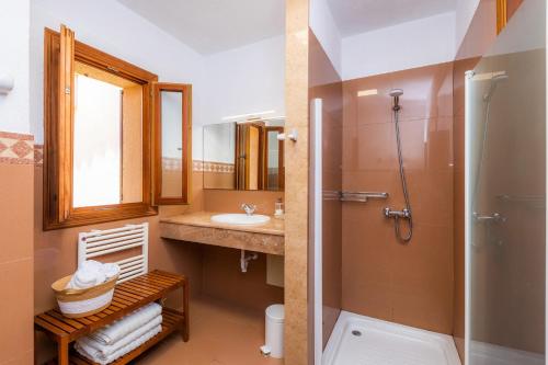a bathroom with a sink and a shower and a toilet at Finca Ca'n Terrasa in Capdepera