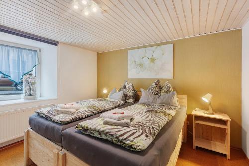 a bedroom with two beds with towels on them at Ferienwohnung Schmidt in Wehr