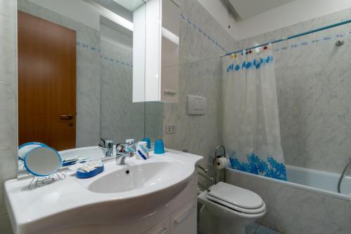 a bathroom with a sink and a toilet and a mirror at Casaentino in Capolona