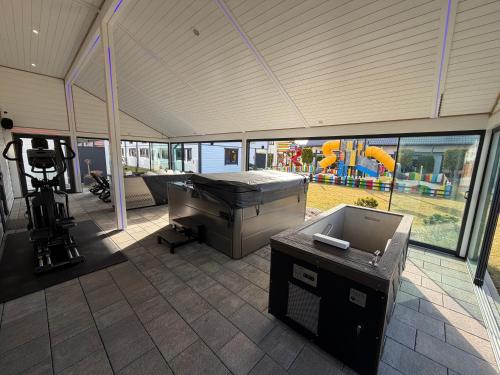 a large room with a pool table and a playground at Amelia Domki in Sianozety