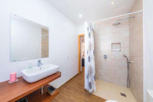 a bathroom with a sink and a shower at Can Binitu in Capdepera
