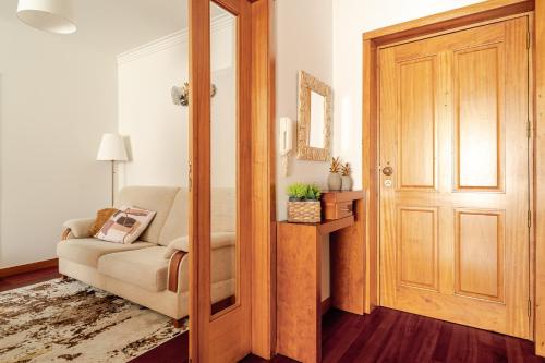 a living room with a chair and a door at Lagoa Residence in Esposende