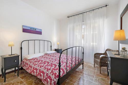 a bedroom with a bed and a table and a chair at Marina in Finale Ligure