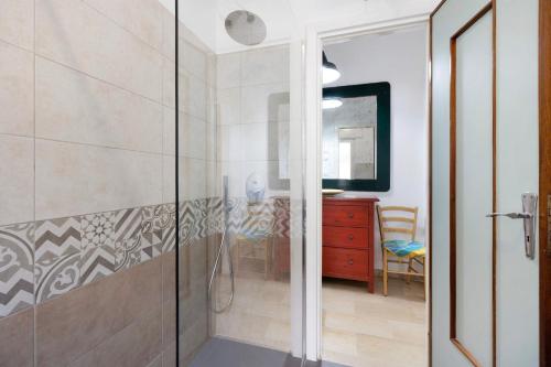 a bathroom with a shower with a glass door at Marina in Finale Ligure