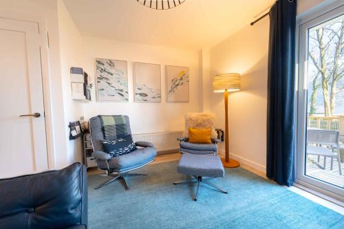 a living room with two chairs and a window at Faodail in Onich