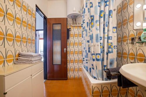 a bathroom with a shower curtain and a sink at Wohnung mit grandiosem Ausblick in Tremosine Sul Garda