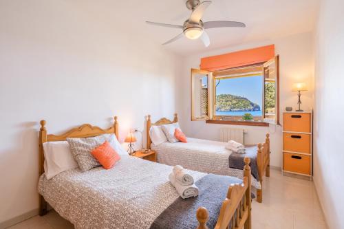 a bedroom with two beds and a window at Bellavista Port de Soller in Port de Soller