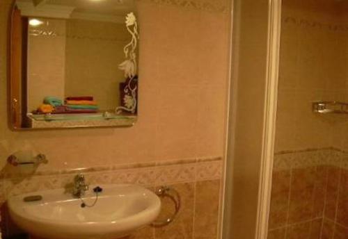 a bathroom with a sink and a mirror at Casa Galesa in Nerja