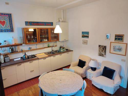 a kitchen with two chairs and a table and a counter at DolceVita Apartments N 241 in Venice