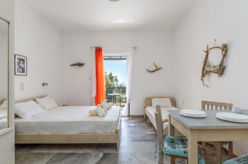 a bedroom with a bed and a table and a dining room at Perasma Studio 1b in Kipri