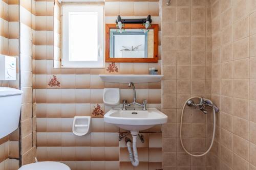 a bathroom with a sink and a toilet and a mirror at Perasma Studio 1b in Kipri