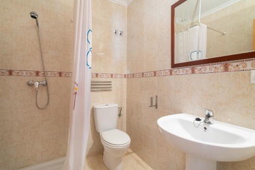 a bathroom with a toilet and a sink and a shower at Bungalow Desired Track in Santa Pola