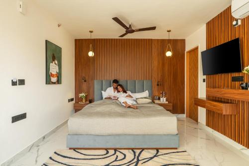 a woman and a child sitting on a bed at Perfectstayz Premium Dehradun at Rajpur road in Dehradun