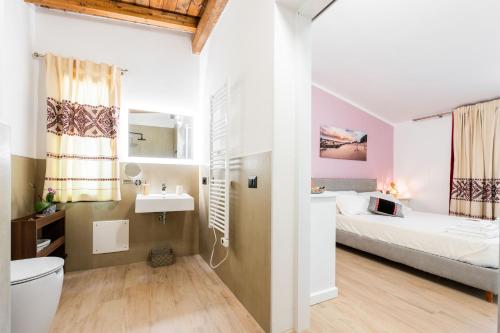 a bathroom with a bed and a sink in a room at Su Carinniu in Villacidro