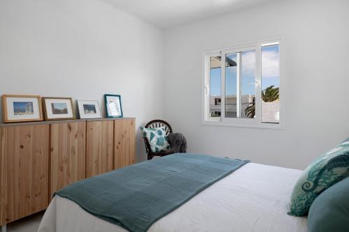 a bedroom with a bed and a window at Casa Fariones in Puerto del Carmen