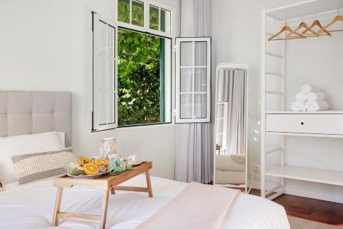 a bedroom with a bed and a table with fruit on it at A Minha Casa in Funchal