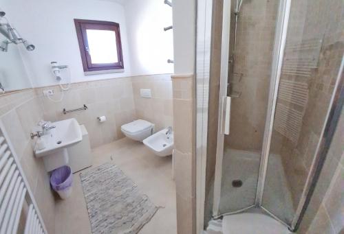 a bathroom with a shower and a toilet and a sink at C 210 Puntavilla in La Maddalena