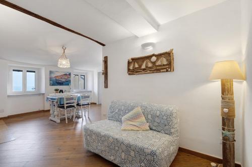 a living room with a chair and a table at Bedliving Nel Blu in Genoa