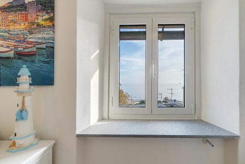 a window in a bathroom with a cake on a toilet at Bedliving Nel Blu in Genoa