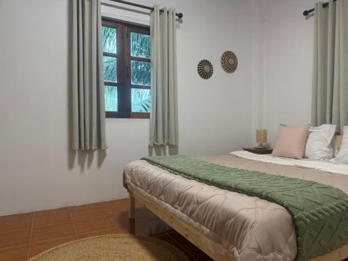 a bedroom with a bed and a window at Siam phangan in Ko Phangan