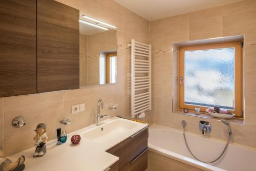 a bathroom with a tub and a sink at Apartment Pustertal in Mühlbach