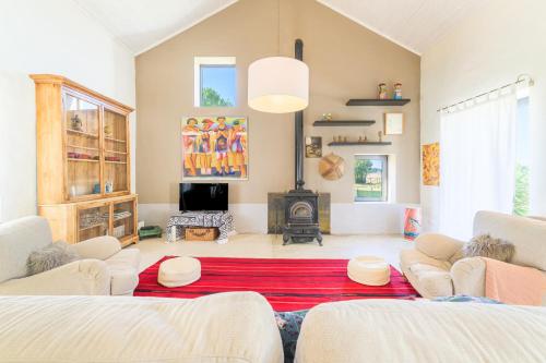 a living room with two couches and a fireplace at Espaço Fataca - Sw Alentejano in São Teotónio