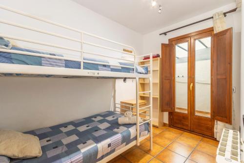 a bedroom with two bunk beds and a door at Apartament Potxó in Olp