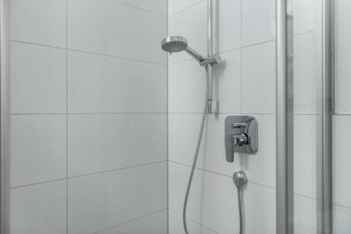 a shower with a shower head in a bathroom at Fewo Köse in Uhldingen-Mühlhofen