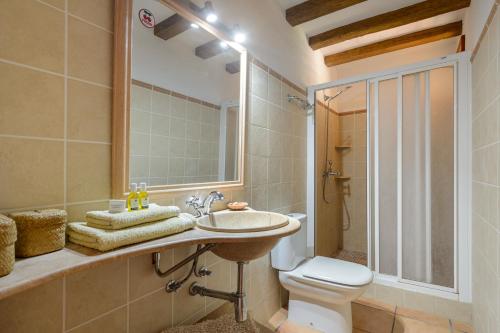 a bathroom with a sink and a toilet at Casa Es Pins in Santa Eularia des Riu