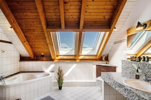 a bathroom with a tub and a sink at Appartement Männerleben in Harztor